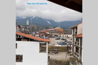 a view of a town with a mountain in the background at Large Gondola Apartment - Center, Neon in Bansko