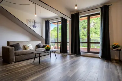 a living room with a couch and a table at Urban Music Studio byPMM in Plovdiv