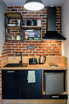 a kitchen with a sink and a brick wall at Urban Music Studio byPMM in Plovdiv
