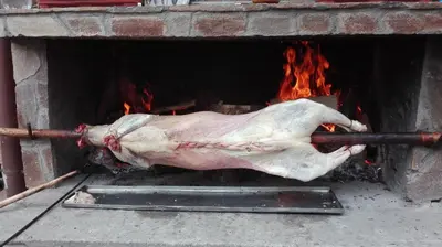 a turkey is being cooked in a brick oven at Къща за гости Камината in Trigrad