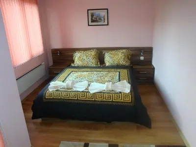 a bedroom with a large bed in a room at Tzvetelina Palace Hotel in Dolna Banya