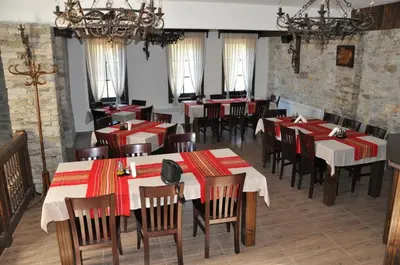 a restaurant with red and white tables and chairs at Galabova Guesthouse in Delchevo
