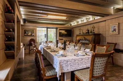 a dining room with a long table and chairs at Villa Vuchev in Velingrad