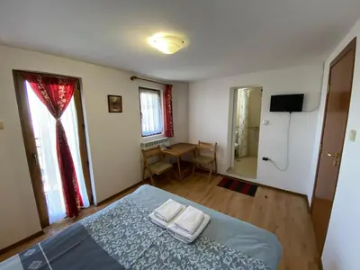 a bedroom with a bed with two towels on it at Villa Pontica in Sofia