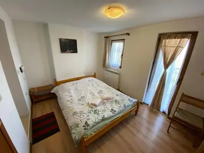 a small bedroom with a bed and a window at Villa Pontica in Sofia