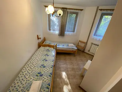 a room with two beds and two windows at Villa Pontica in Sofia