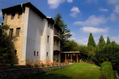 a large stone building with a yard in front of it at Villa Pontica in Sofia