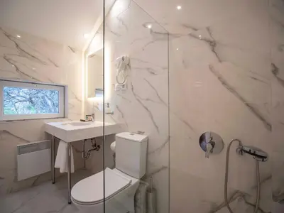 a bathroom with a toilet and a sink and a shower at The Moon Boutique Hotel in Sofia