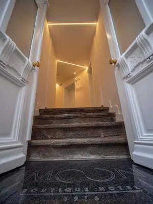 a hallway with stairs with a sign on the floor at The Moon Boutique Hotel in Sofia