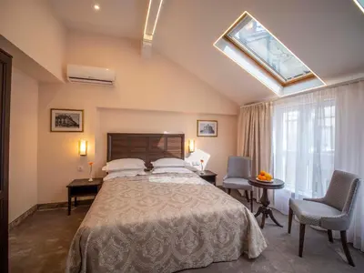 a bedroom with a bed and a desk and a window at The Moon Boutique Hotel in Sofia