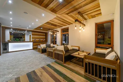 a living room with a couch and a table at 103 Alpine Hotel in Panichishte