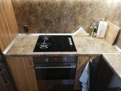 a kitchen with a stove and a counter top at Приключение в Триград in Trigrad