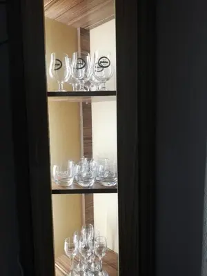 a bunch of wine glasses sitting on a shelf at Приключение в Триград in Trigrad