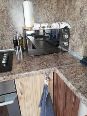 a microwave sitting on a counter in a kitchen at Приключение в Триград in Trigrad