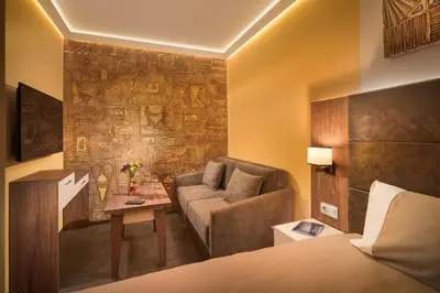 a hotel room with a couch and a table at АРТ СТУДИО СОФИЯ in Sofia