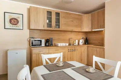 a kitchen with a table and a microwave at Апартамент В4 in Velingrad