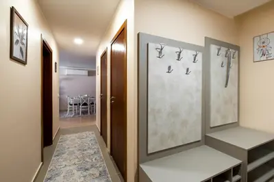 a hallway with a door and a dining room at Апартамент В4 in Velingrad