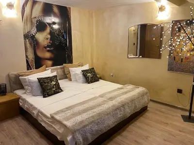 a bedroom with a bed with a large painting on the wall at Paradise in the Mountain in Bansko