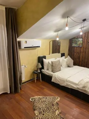 a bedroom with a bed and a leopard print rug at Paradise in the Mountain in Bansko