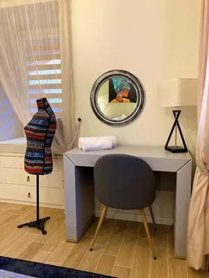 a desk with a chair and a mirror at Diva Garden Apartment in Plovdiv