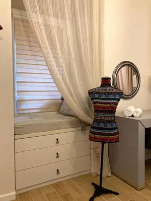 a bed with a window with a curtain at Diva Garden Apartment in Plovdiv