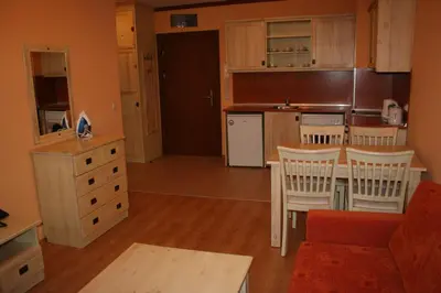 a kitchen with a table and chairs in a room at Saint Ivan Ski Apartments in Bansko
