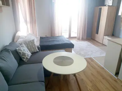 a living room with a couch and a table at Saint Ivan Ski Apartments in Bansko