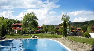 a large swimming pool in a yard with houses at Къща за гости Volpe - Volpe Guesthouse in Oreshak