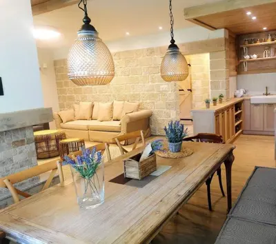 a living room with a wooden table and a couch at Къща за гости Volpe - Volpe Guesthouse in Oreshak