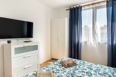 a bedroom with a flat screen tv and a bed at Bendida Central in Velingrad