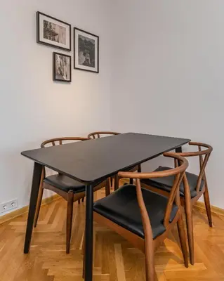 a black table and chairs in a room at Industrial 2-BDR Flat by the National Stadium by Flat Mаnager in Sofia