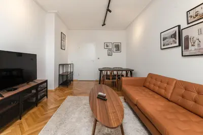 a living room with a couch and a table at Industrial 2-BDR Flat by the National Stadium by Flat Mаnager in Sofia