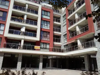 an apartment building with red and white at Azaria in Hisarya
