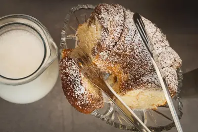 a pastry in a glass bowl next to a glass of milk at Villa Pino in Velingrad