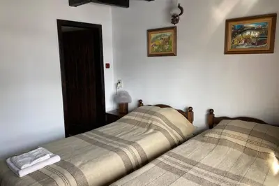 two beds sitting next to each other in a bedroom at Guest House 