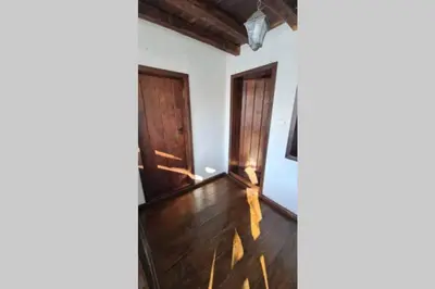 a hallway with wooden floors and wooden doors at Guest House 