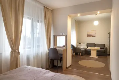 a room with a bed and a mirror and a desk at Червената къща in Perushtitsa