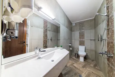 a bathroom with a sink and a toilet at Българче Хотел - Ресторант in Smolyan