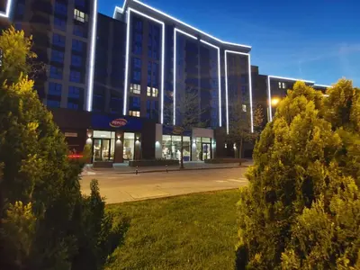 a large building with a park in front of it at Niko's Cozy Apartment in Plovdiv