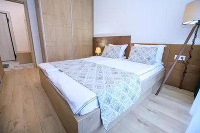 a bedroom with a large bed in a room at Лукс Апартамент Радост 2 in Sandanski