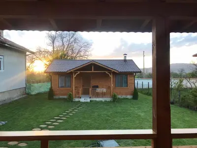 a log cabin in the yard of a house at Къщи за гости Михайлови in Sapareva Banya