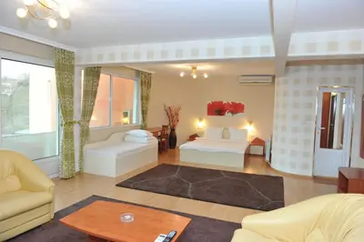 a living room with a bed and a couch at Eros Motel in Sandanski