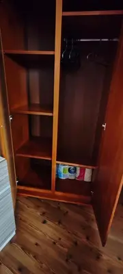a wooden cupboard with a book shelf in a room at iVAVev CedarLodge Bansko in Bansko