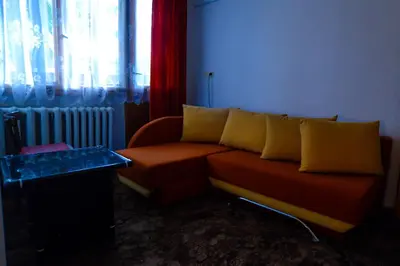 a living room with a couch and a window at Topuzovi Guest House in Dobrinishte