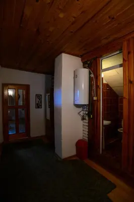 a hallway with a room with a door and a window at Topuzovi Guest House in Dobrinishte