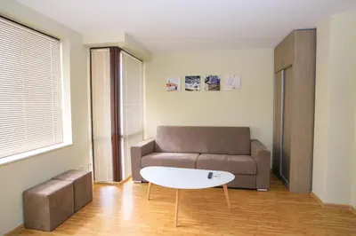 a living room with a couch and a coffee table at Feel at Home in Sandanski