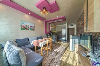 a living room with a couch and a table at Sweet Home апартамент 530 Смолянски езера in Smolyan