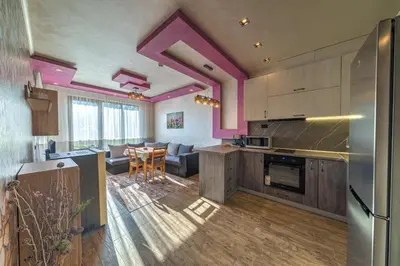 a kitchen and living room with purple walls at Sweet Home апартамент 530 Смолянски езера in Smolyan