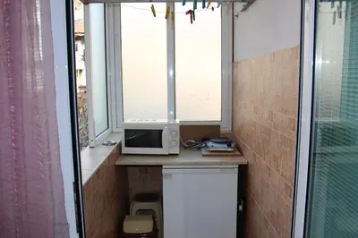 a small bathroom with a microwave and a window at Orchideia Studios in Sandanski