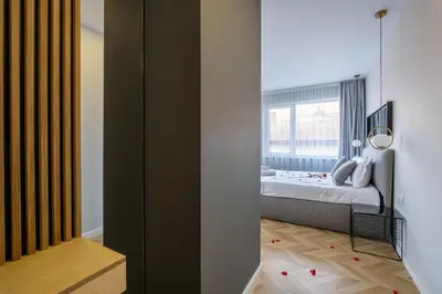 a bedroom with a bed and a window at Студио с вана и гледка в 